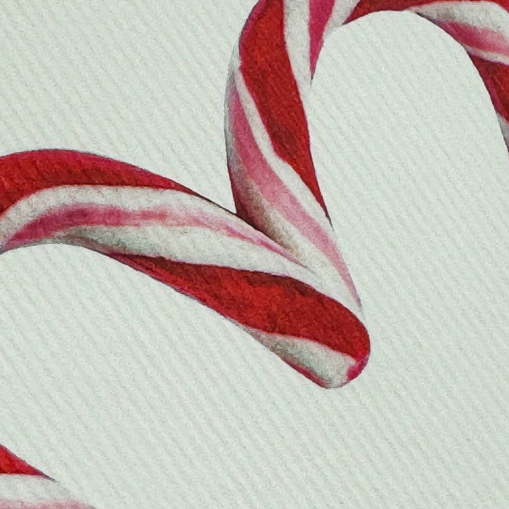 Close-up of red and white striped candy canes on a textured surface