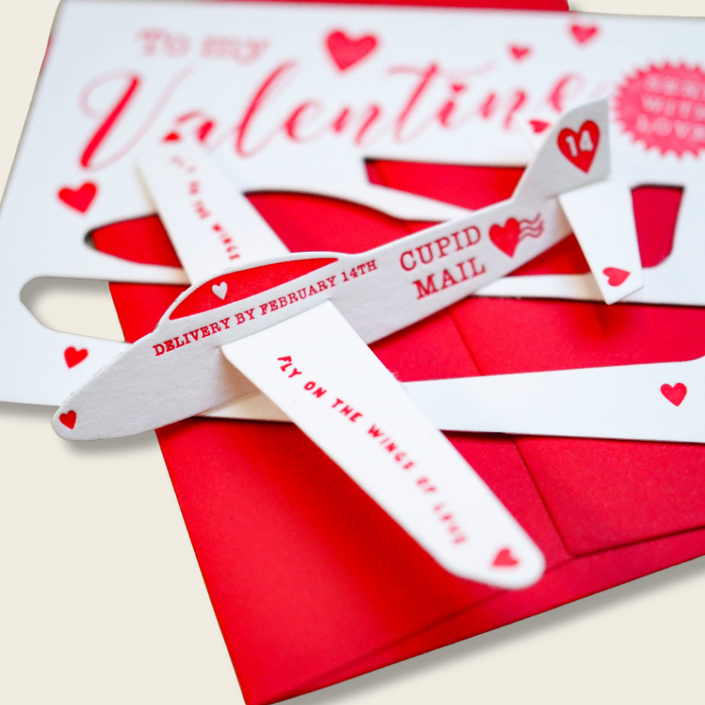 Valentine's Day card with white wings and red envelope