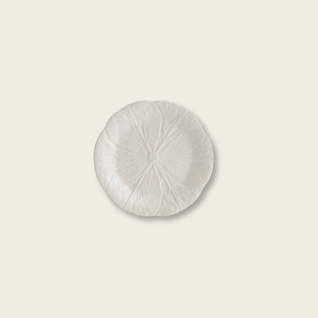 Round white ceramic plate on a beige background