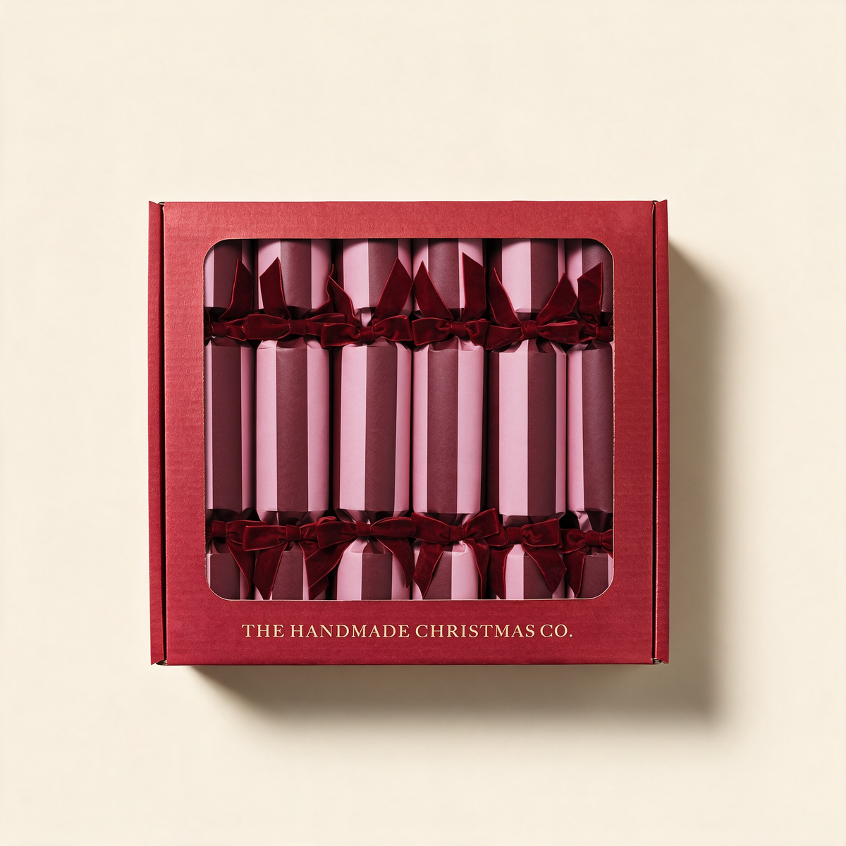 Crimson Blush handmade luxury Christmas crackers, set of six in berry red and blush, on a cream background