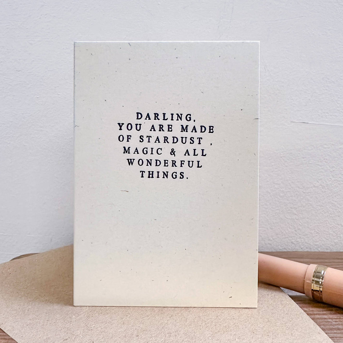 Motivational card with text on a wooden surface