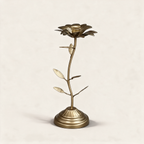 Bronze dahlia-shaped taper candle holder on a warm cream background