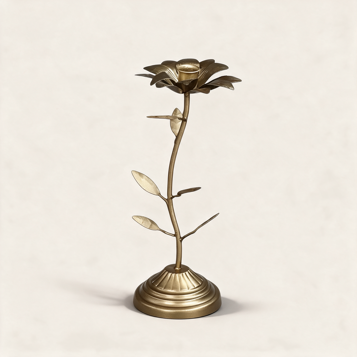 Bronze dahlia-shaped taper candle holder on a warm cream background