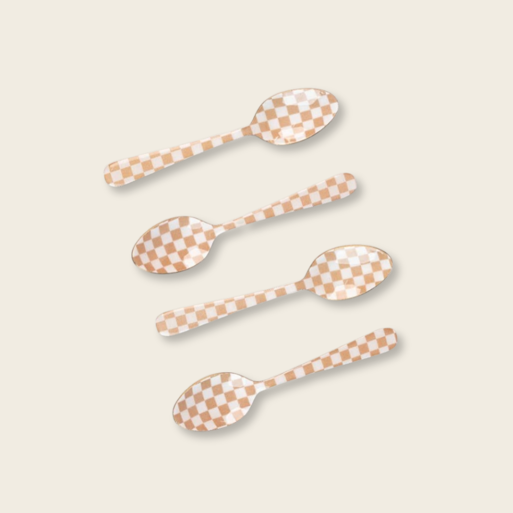Four checkered spoons on a beige background
