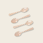 Four checkered spoons on a beige background