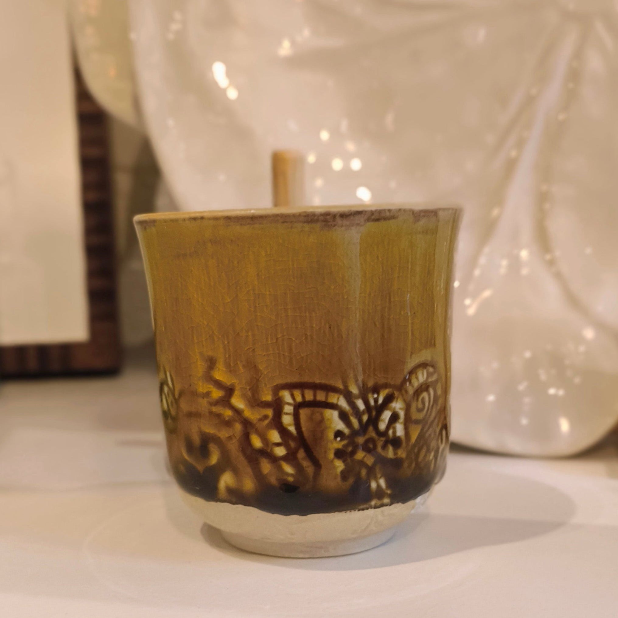 Ceramic cup with decorative patterns on a white surface