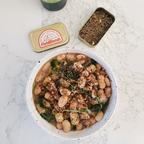 Bowl of food with a can of Field Blends seasoning on a marble surface