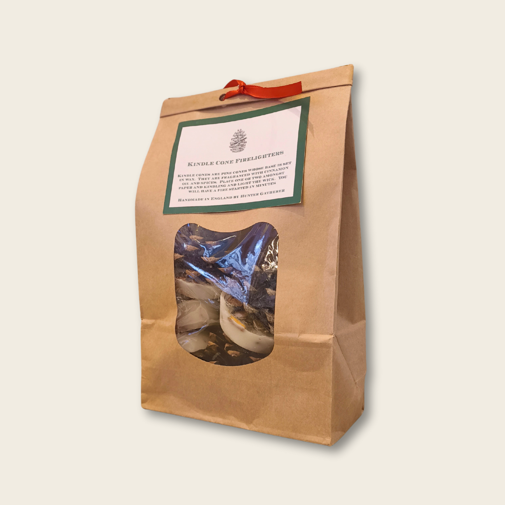 Kraft paper bag with window, containing a blue bag of firelighters, on a beige background.