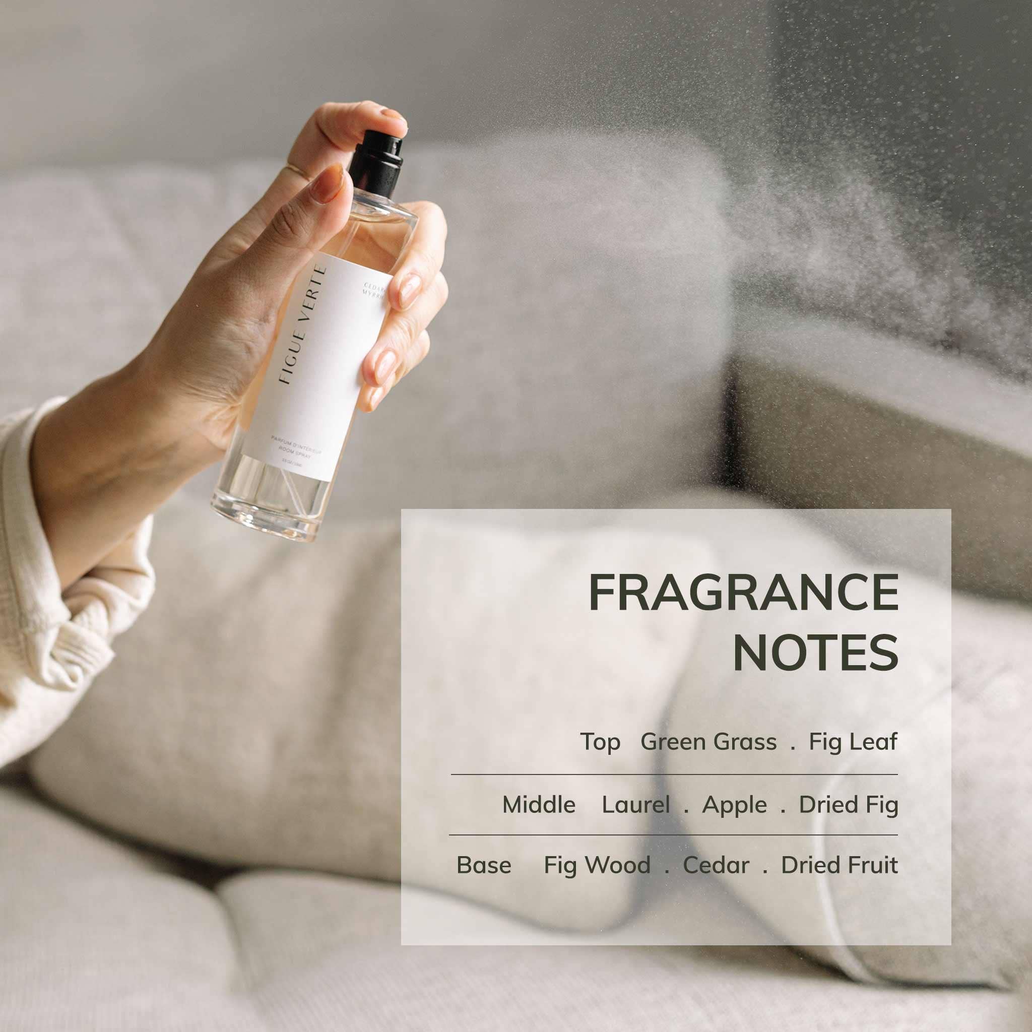 Hand holding a perfume bottle with fragrance notes displayed on a neutral background