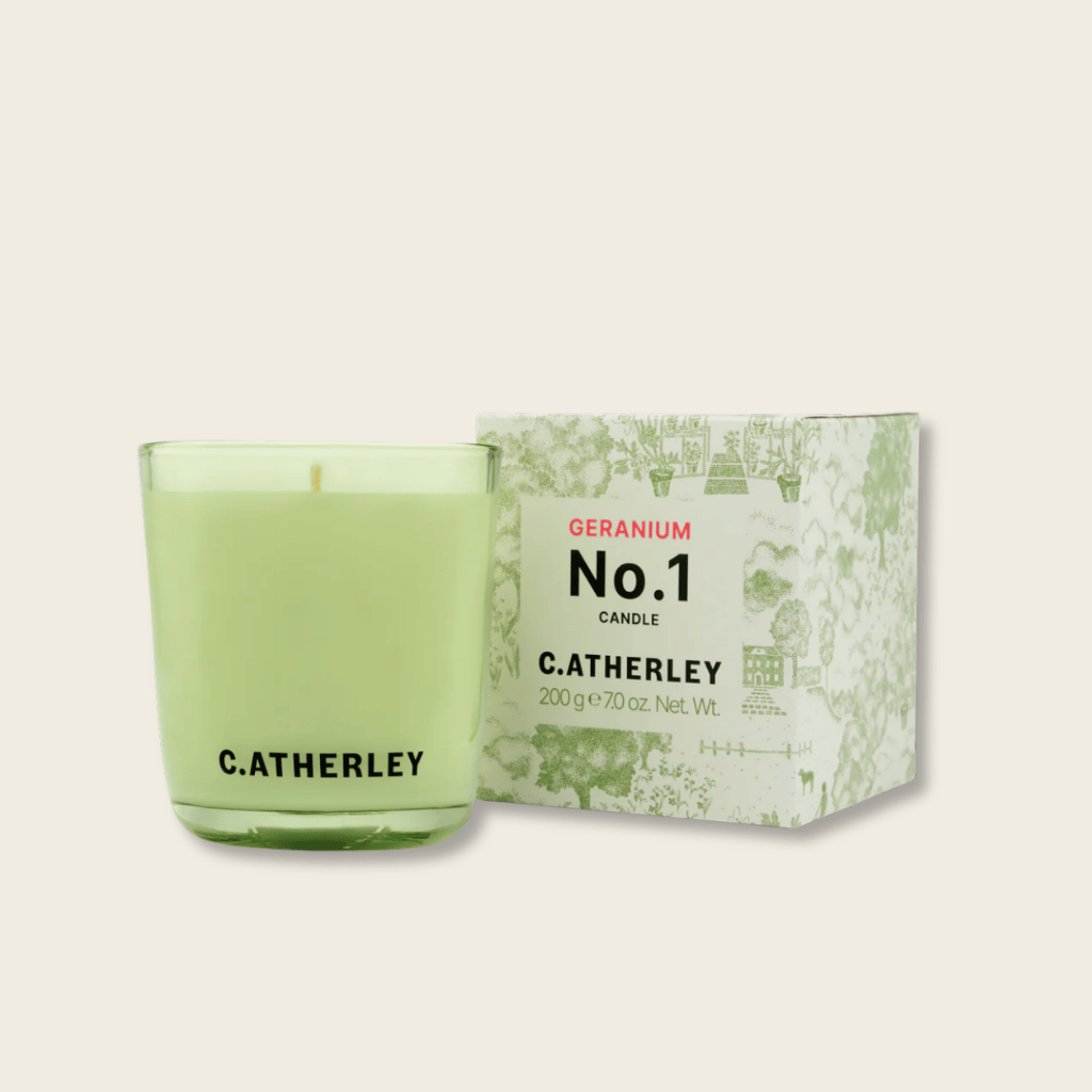 Green candle with packaging featuring 'C. Atherley' branding on a beige background