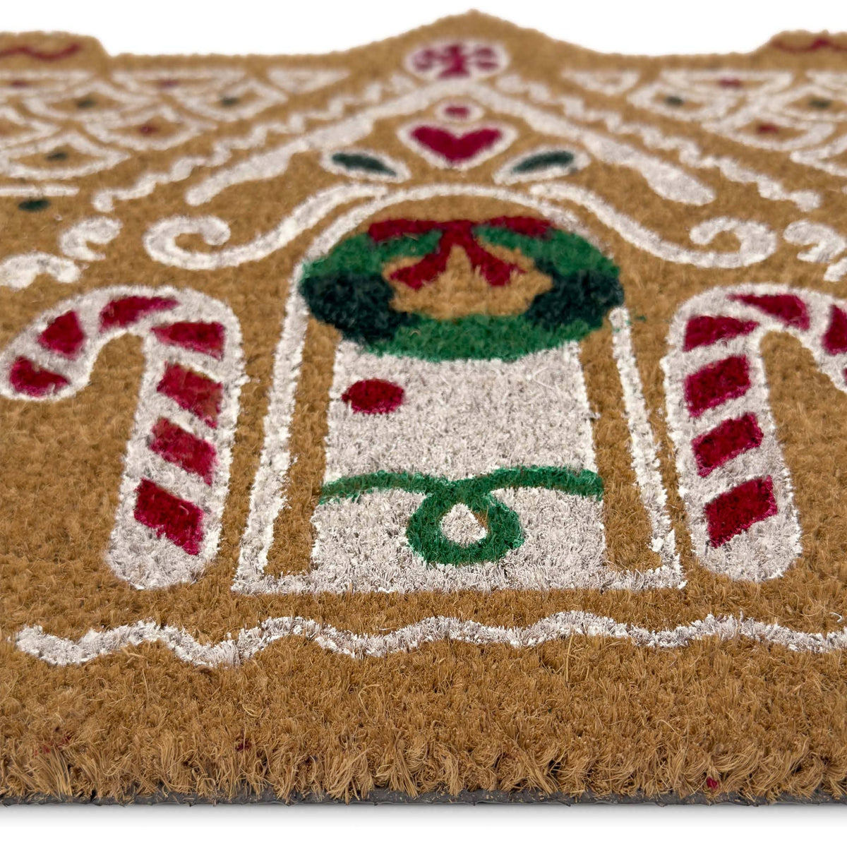 Gingerbread cottage coir doormat shown in a doorway setting