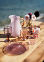 Lilac and caramel glass jug styled on a laid table