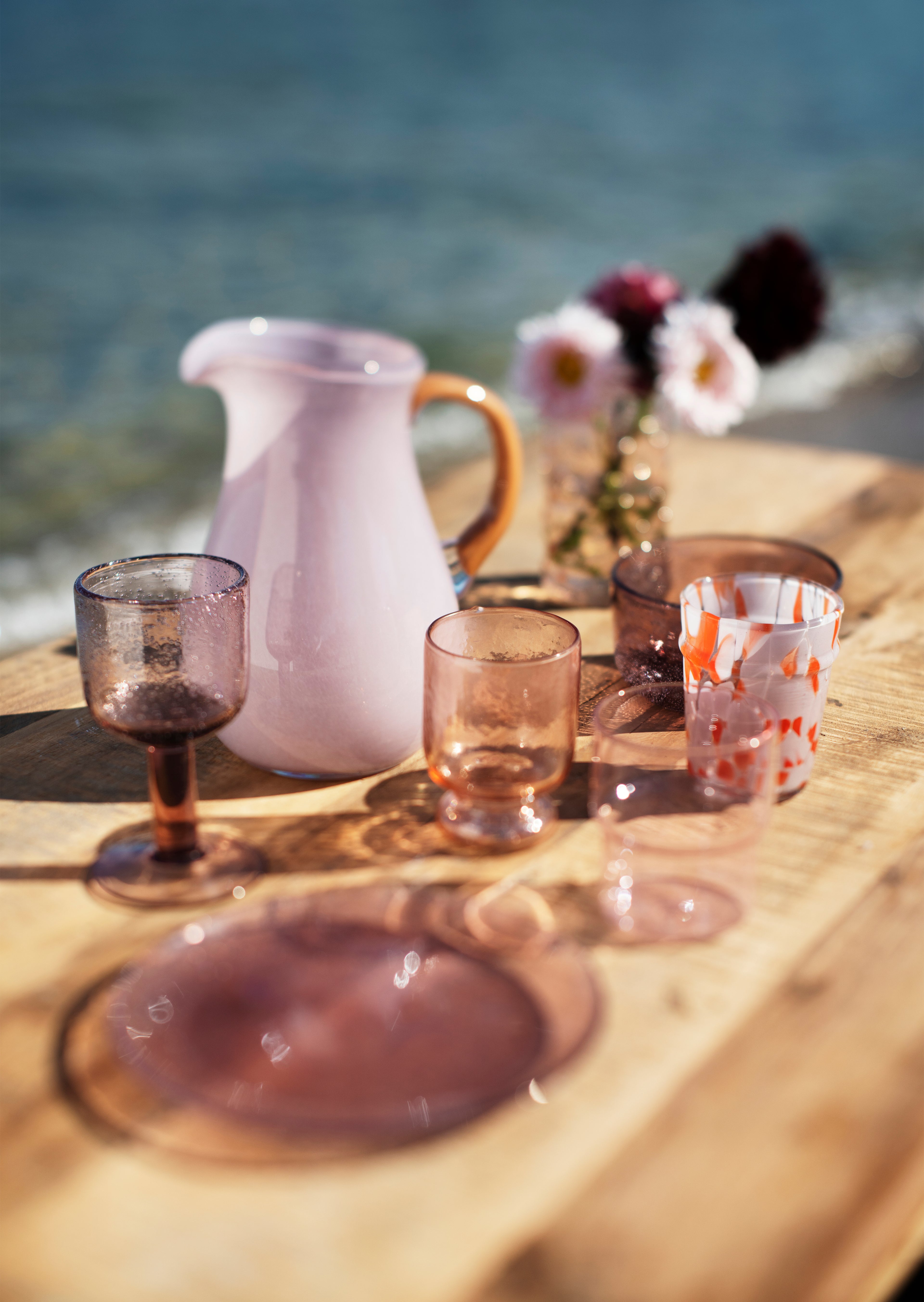 Lilac and caramel glass jug styled on a laid table