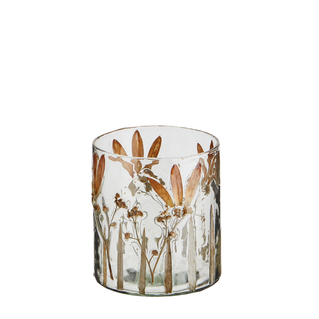 Small glass votive with flower petals set into the glass