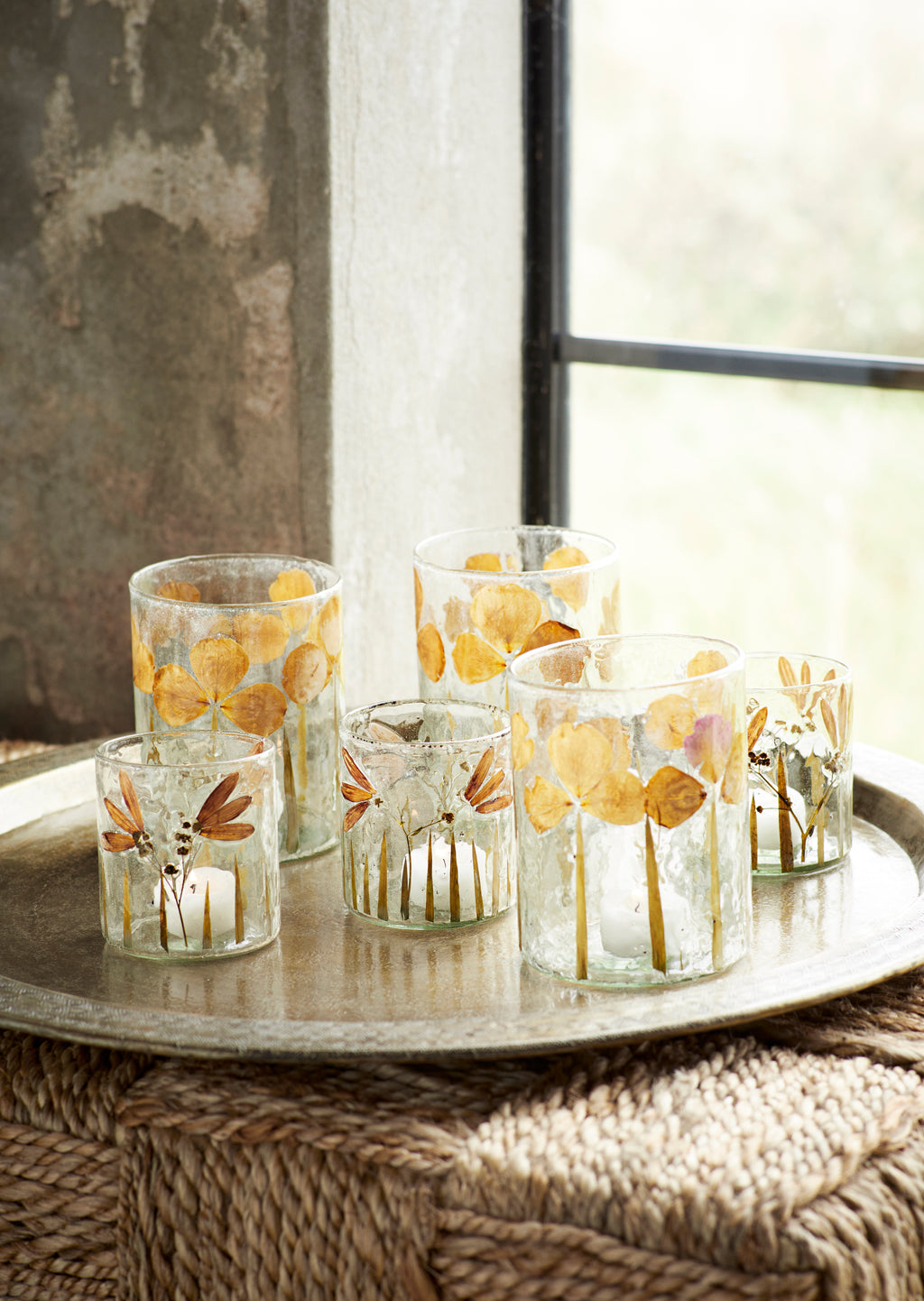 Glass flower votives styled with lit tea lights