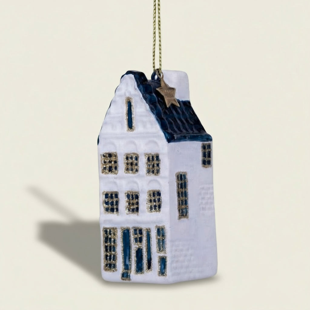 Decorative house ornament with blue accents on a white background