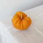 Golden heirloom tomato beeswax candle, close detail of the ribbed golden wax