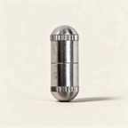Metal good fortune wish capsule with paper scroll on a warm cream background