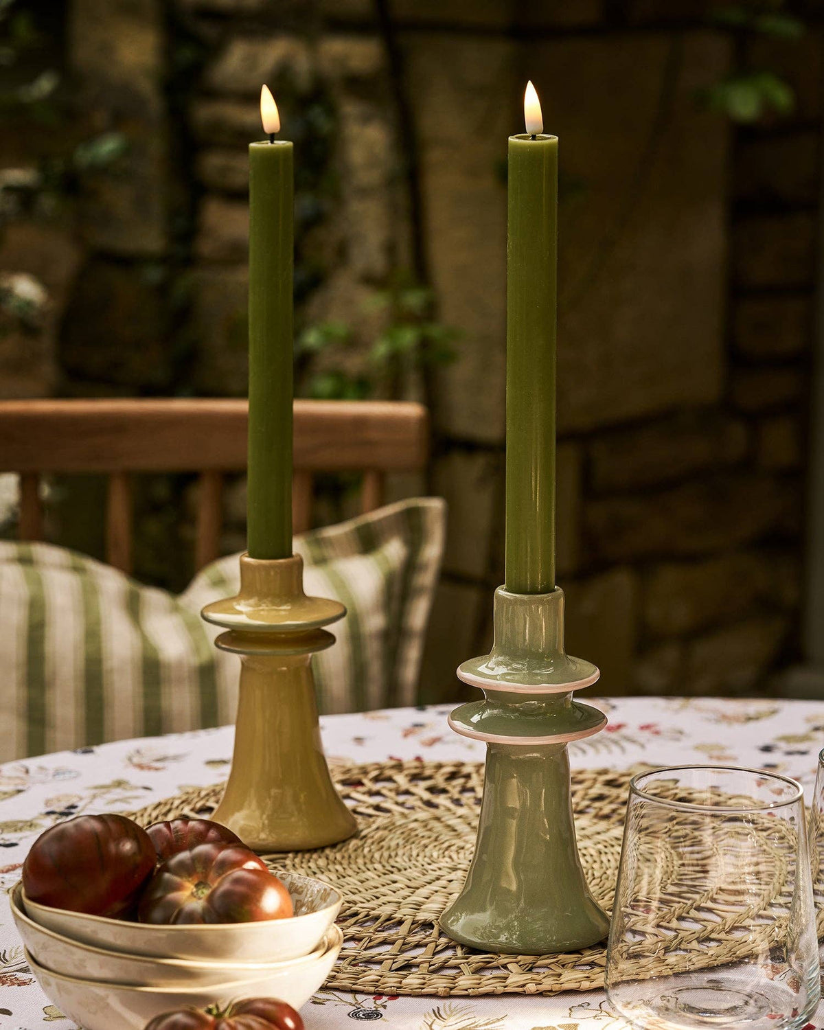 Close-up of the pink rim detail on the green stoneware candlestick