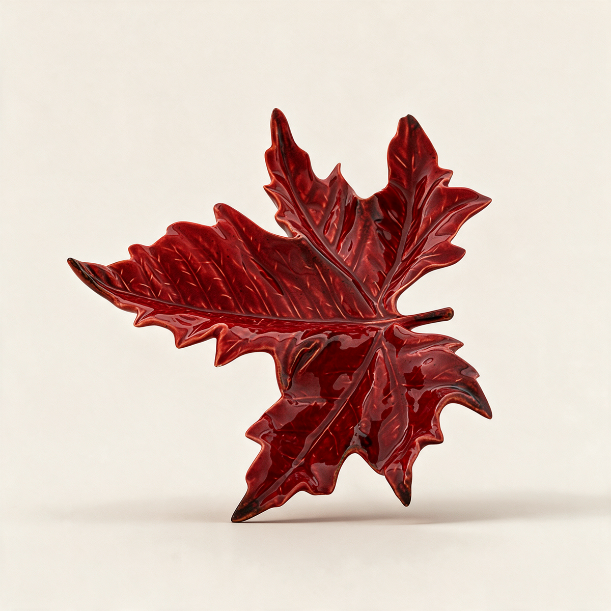 Red hand-painted earthenware sycamore leaf serving dish from the Gudrun collection