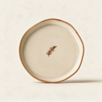 Hand painted pine snack plate in matte cream stoneware on a cream background