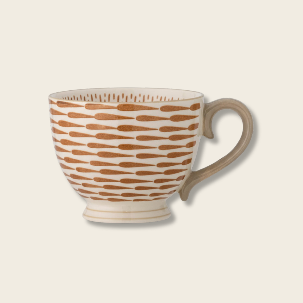 White mug with brown pattern on a white background