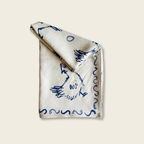 Folded fabric with blue patterns on a beige background