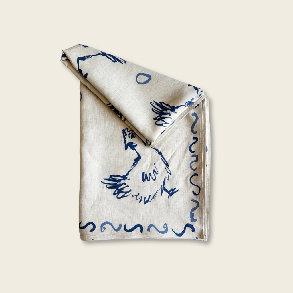 Folded fabric with blue patterns on a beige background