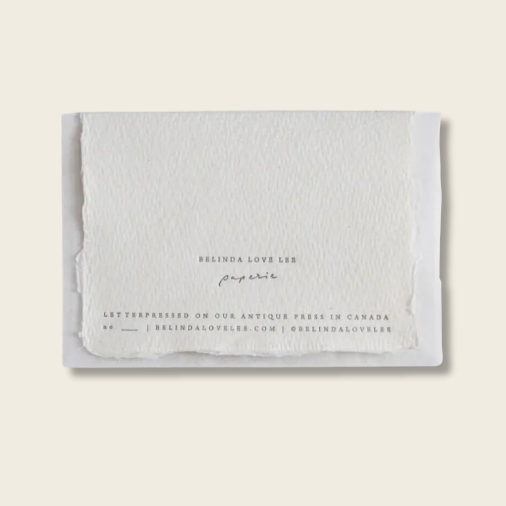 Handmade cotton rag paper card with letter pressed text on the back . 