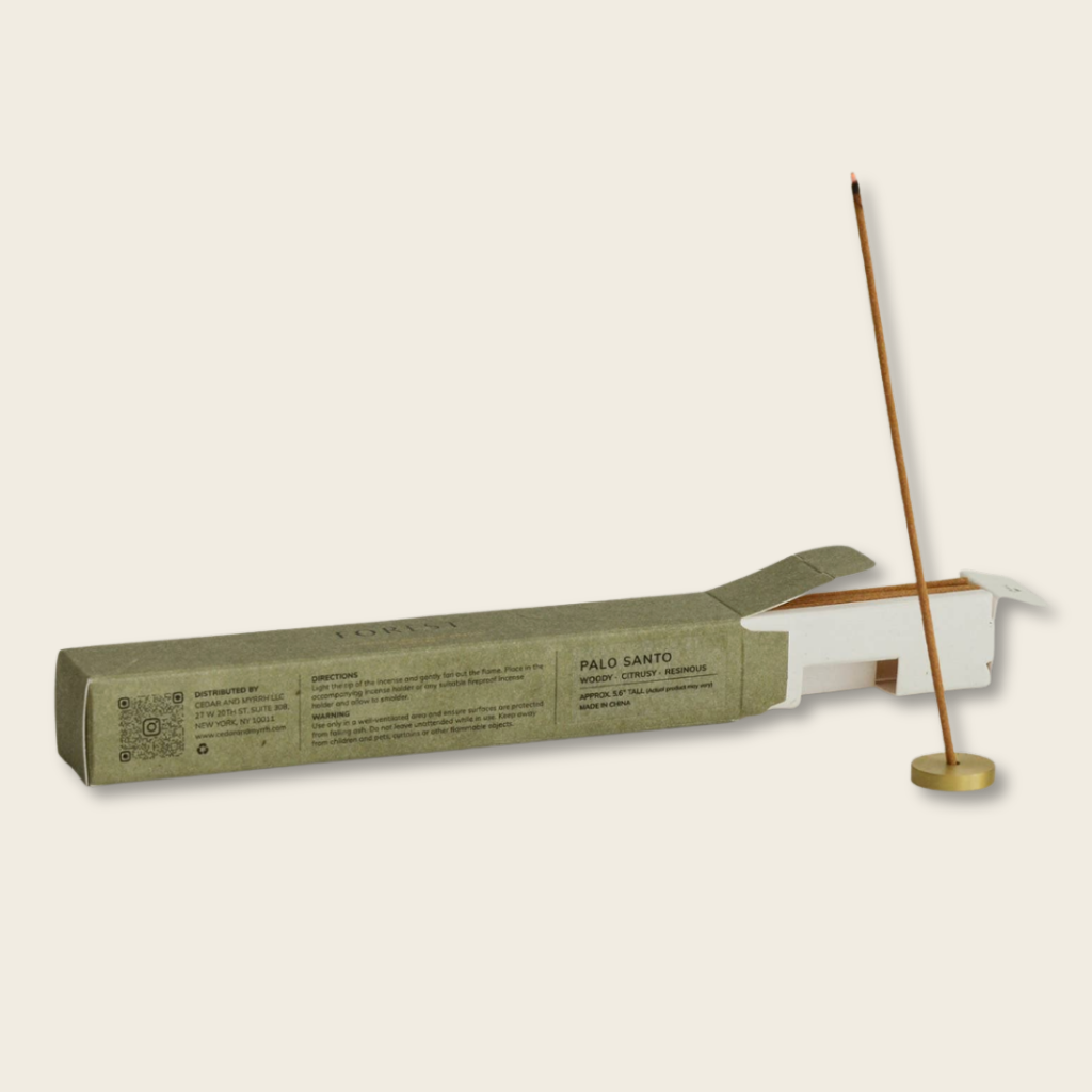 Incense stick with packaging on a light beige background