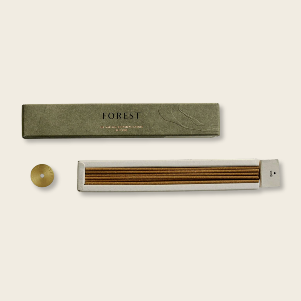 Incense stick set with packaging labeled 'Forest' on a beige background