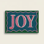 Doormat with 'JOY' text on a blue background