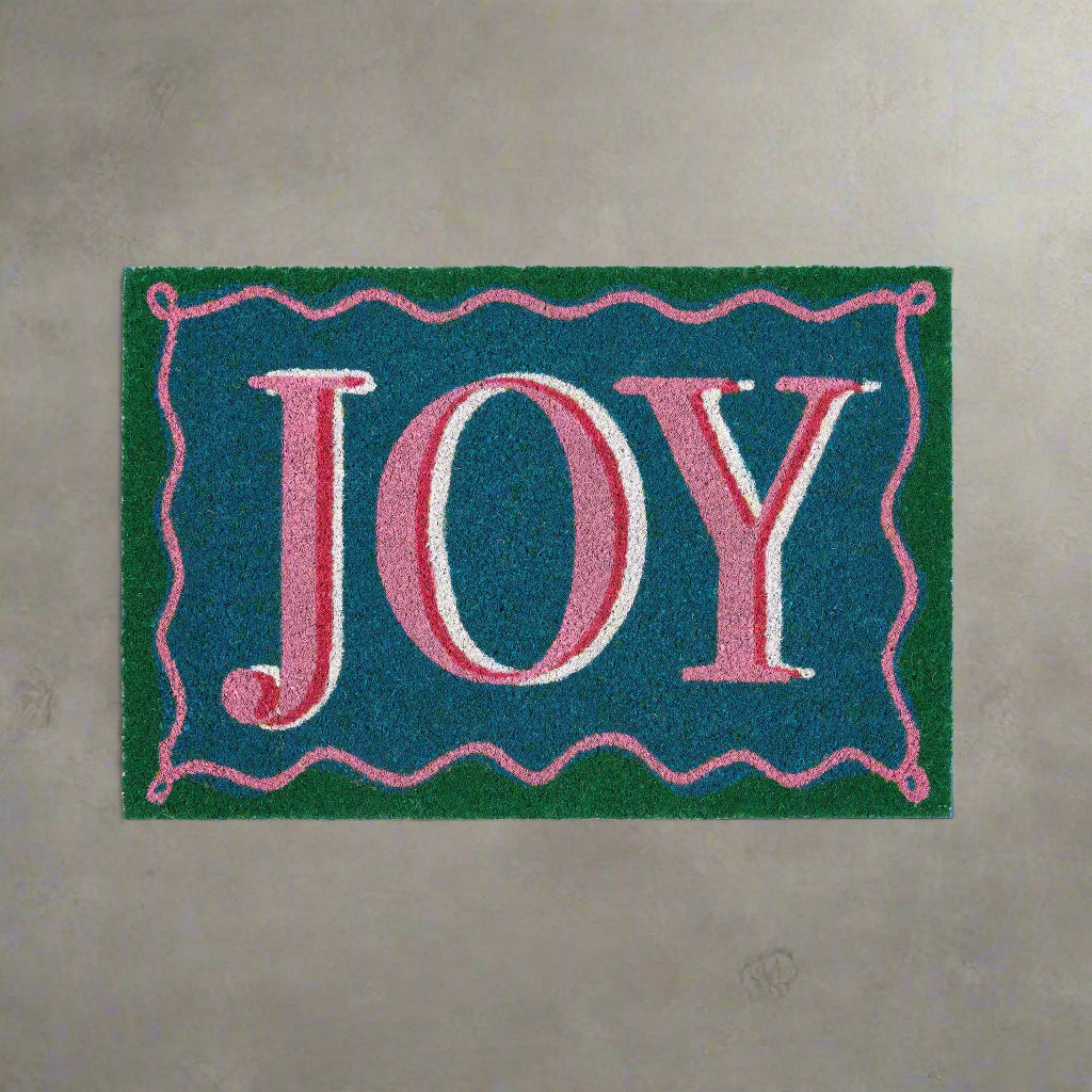 Doormat with 'JOY' text on a blue background
