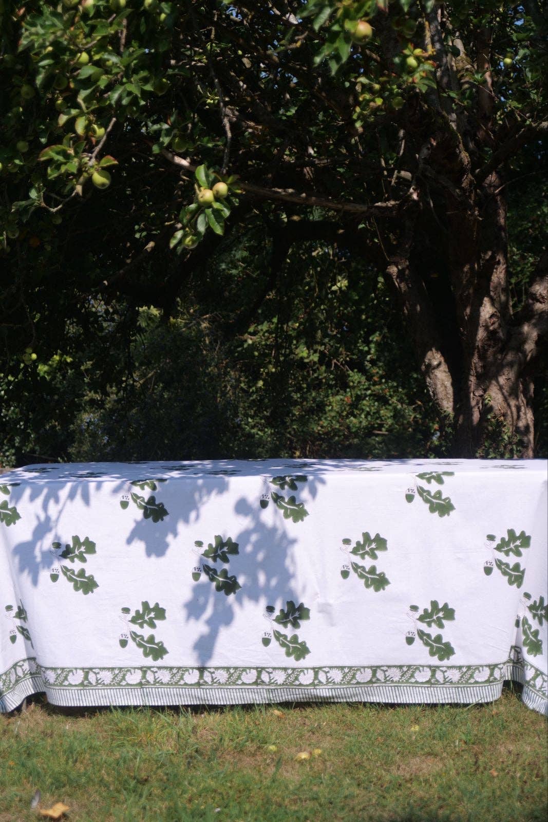 Khaki oak leaf cotton tablecloth laid across a table