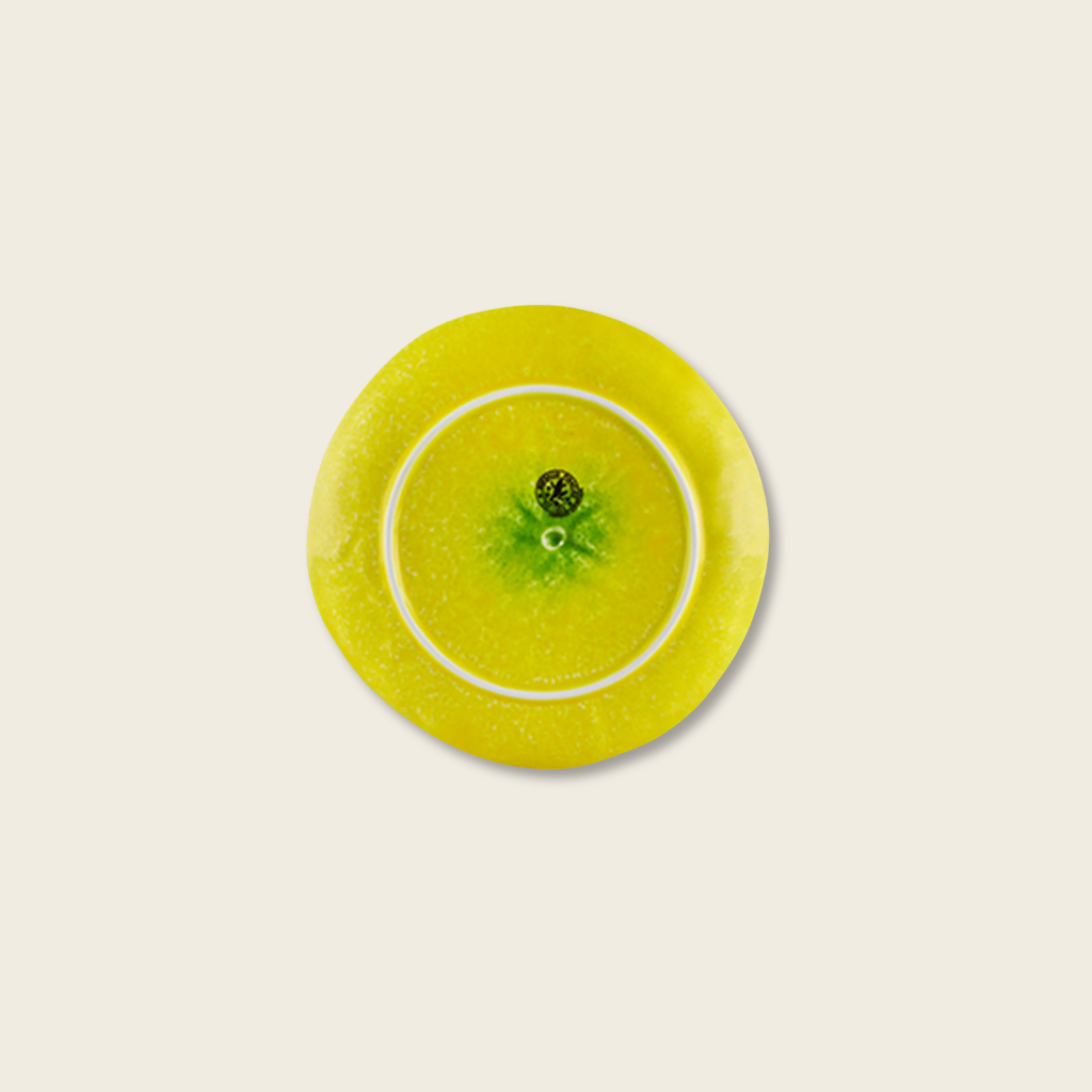 Yellow circular object with a white rim on a beige background