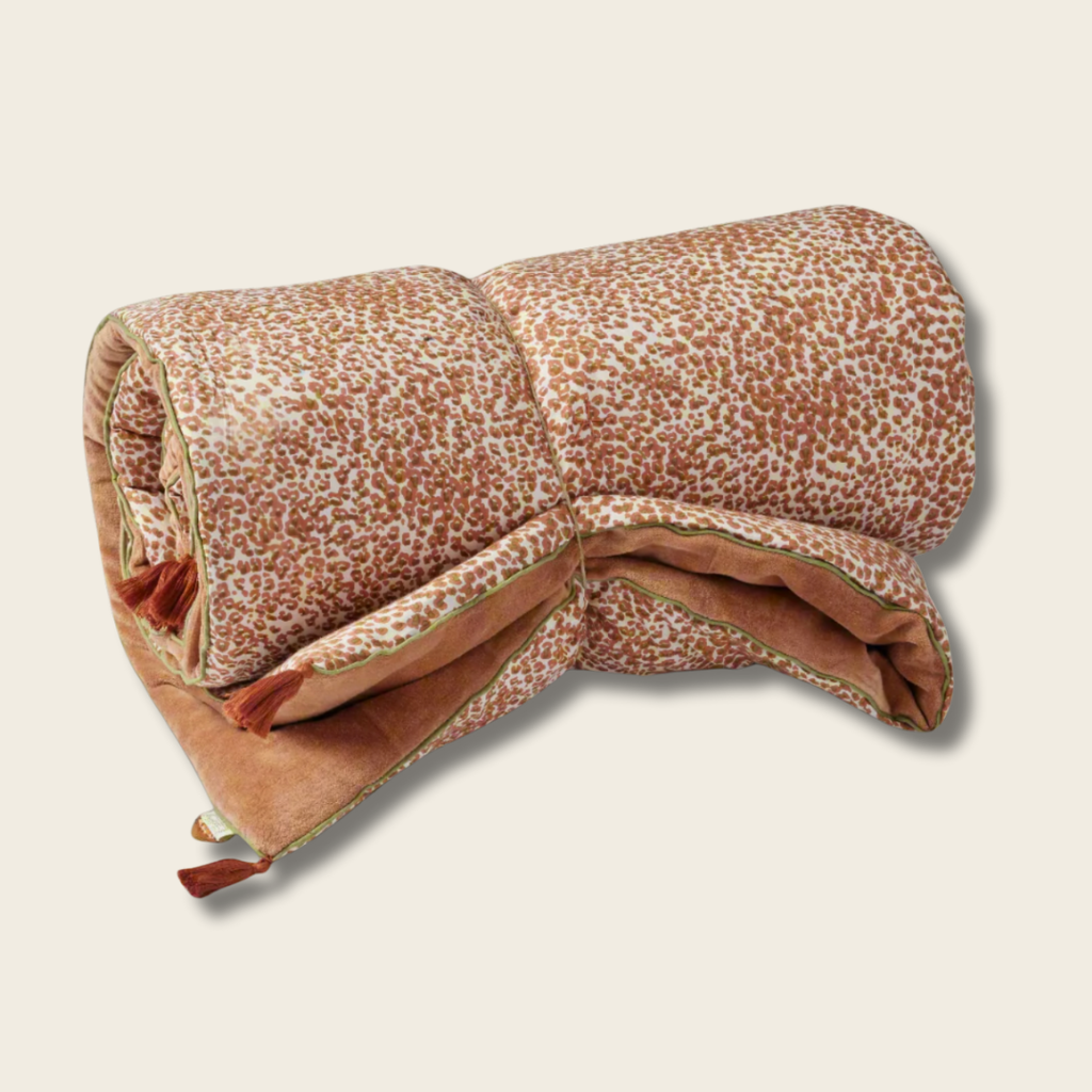 Folded blanket with a pattern on a beige background