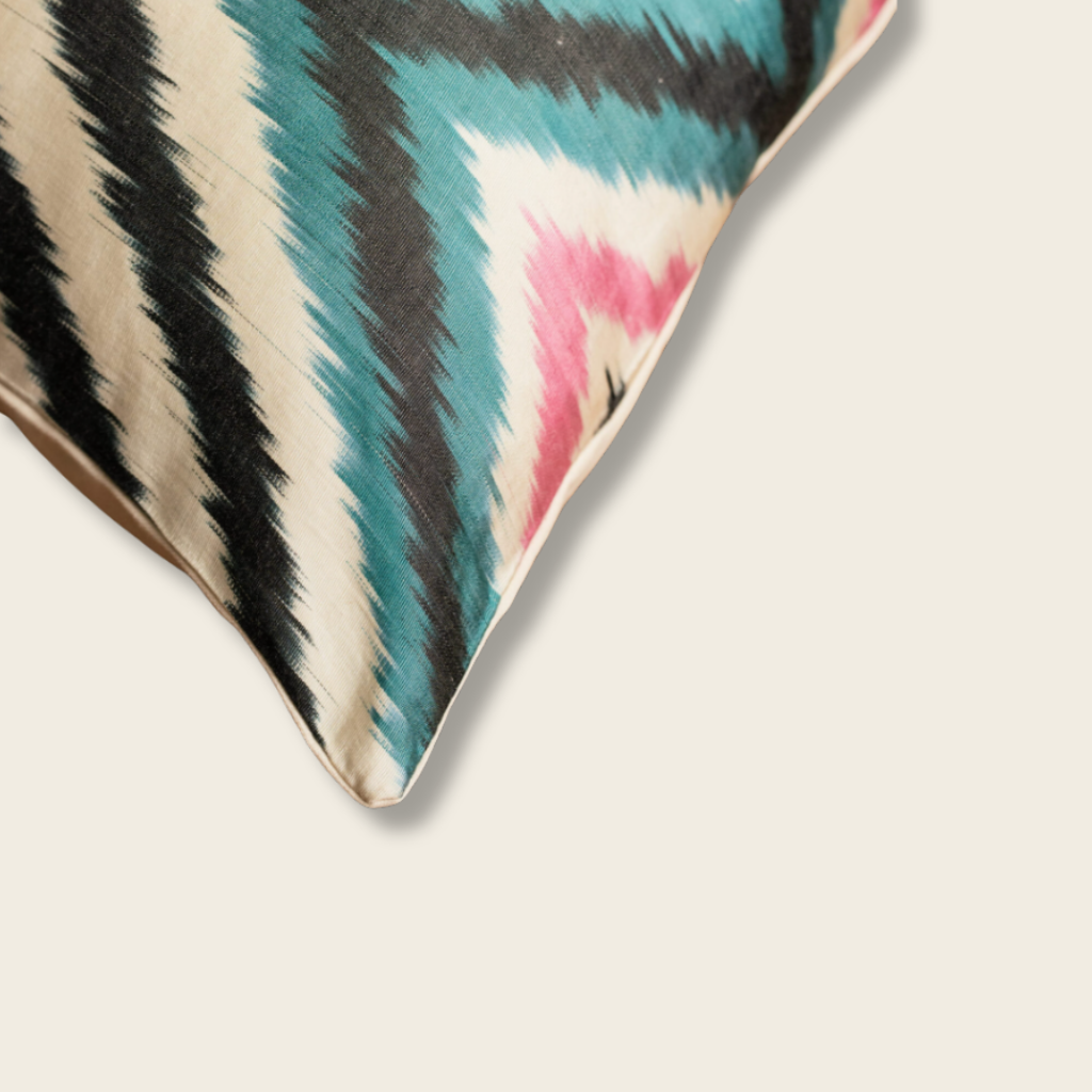 close up of a cushion corner with black pink and cream bold pattern