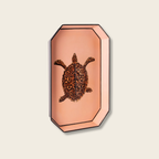 Decorative tray art with a turtle design on a textured wall