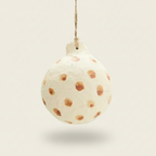 Decorative ornament resembling a tortilla with brown spots on a white background
