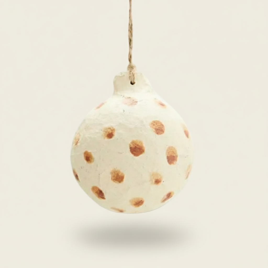 Decorative ornament resembling a tortilla with brown spots on a white background
