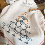 Decorative towel with wine glass design on a table setting