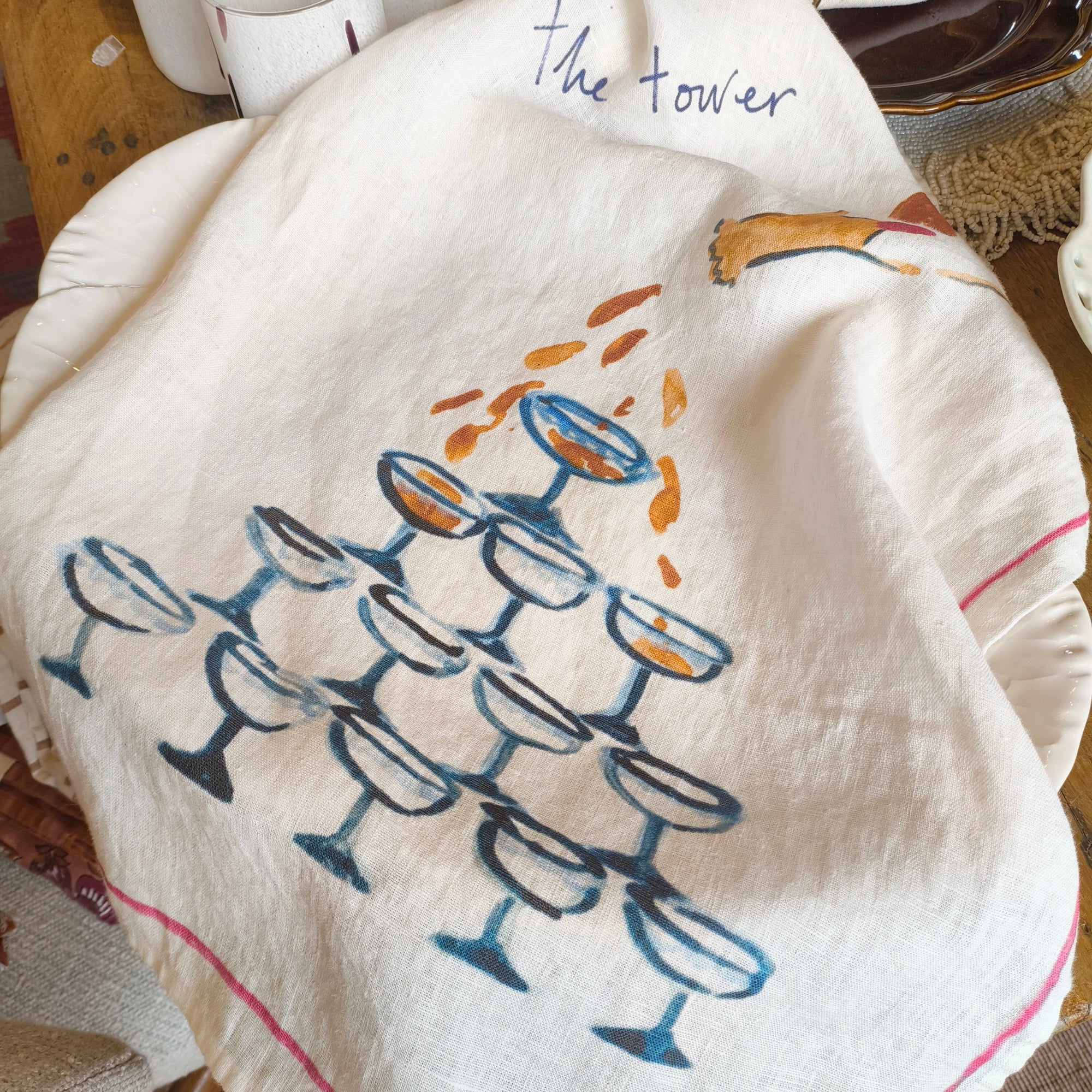 Decorative towel with wine glass design on a table setting
