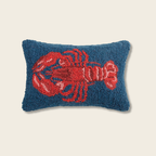 Decorative pillow with a red lobster design on a blue background