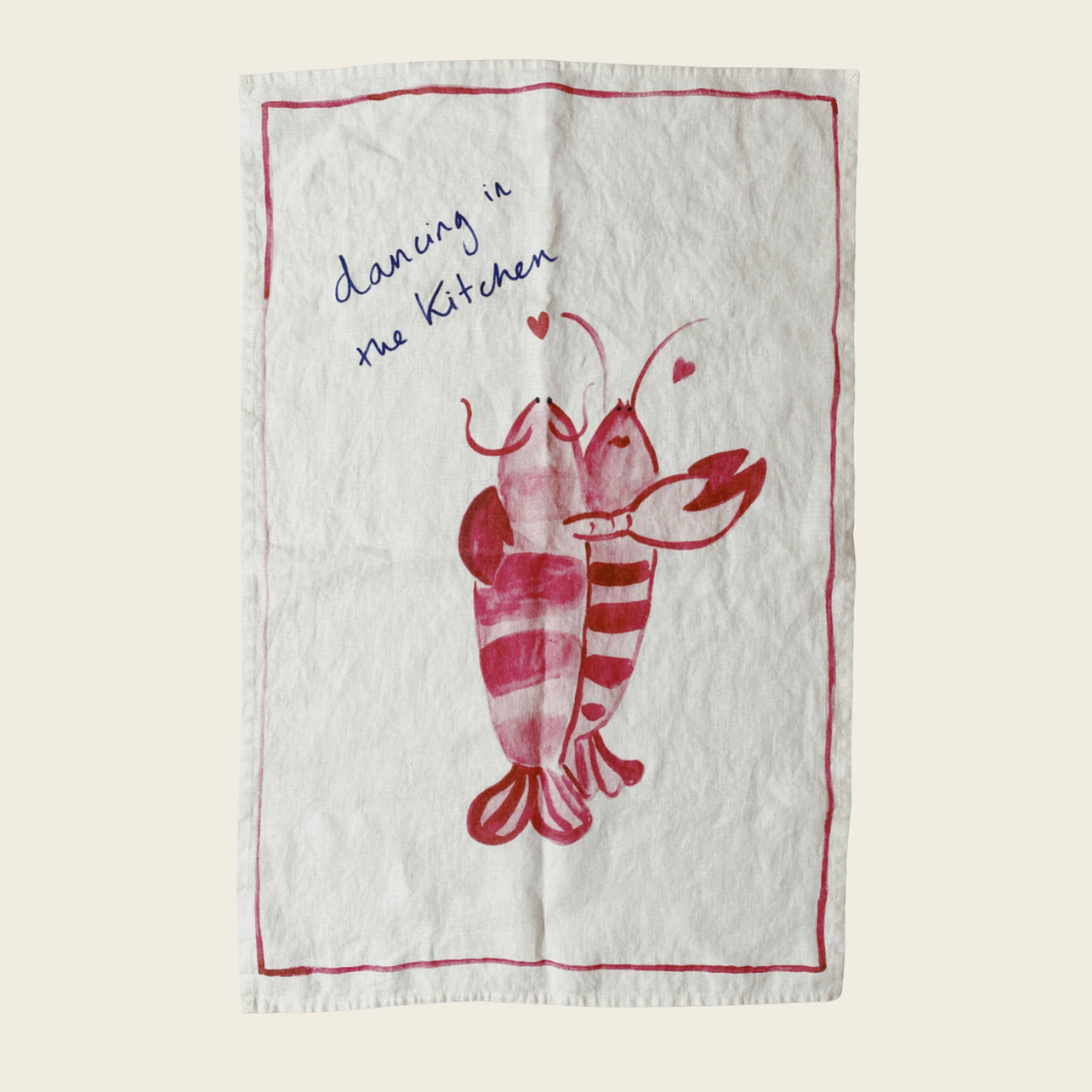 tea towel with dancing lobster print and text saying dancing in the kitchen