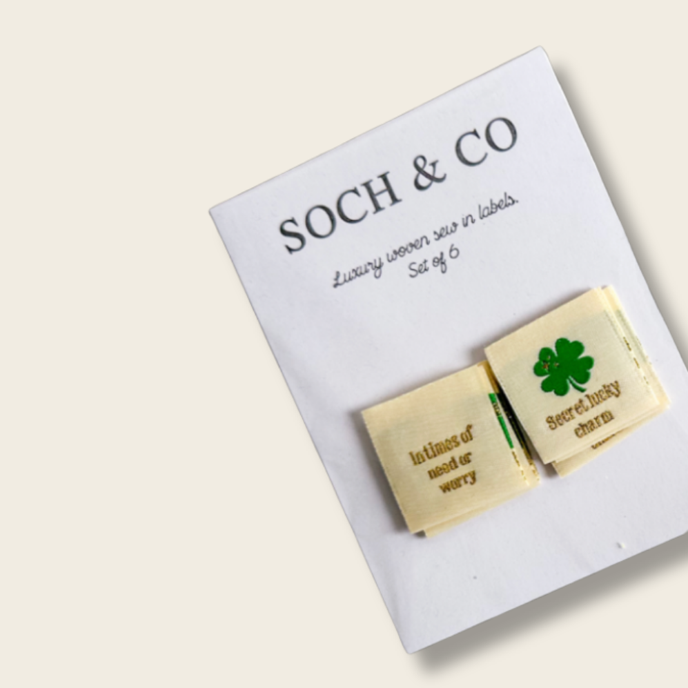 Two sew in labels text and a clover design on a 'SOCH & CO' branded card.