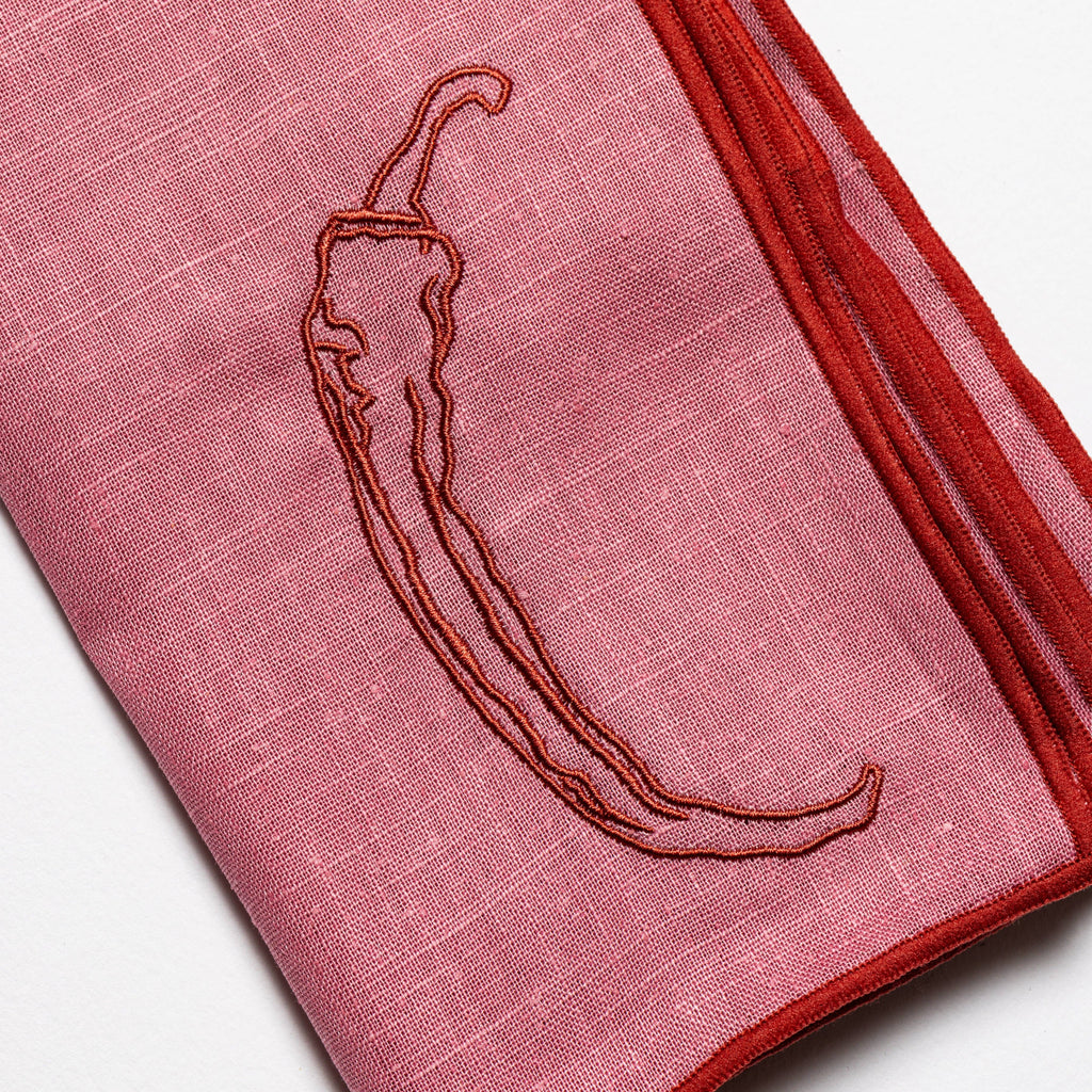Chilli print linen napkins at a place setting