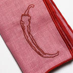 Chilli print linen napkins at a place setting