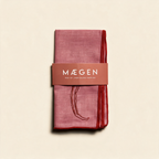 Set of two MÆGEN chilli-print linen blend napkins on a cream background