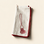 Set of two MÆGEN spaghetti-print linen blend napkins on a cream background
