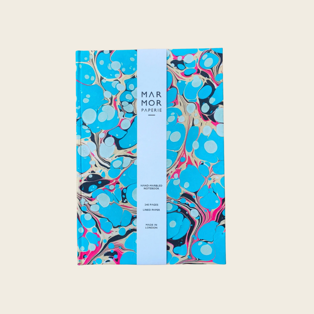 Marbled paper product with blue and black design on a beige background